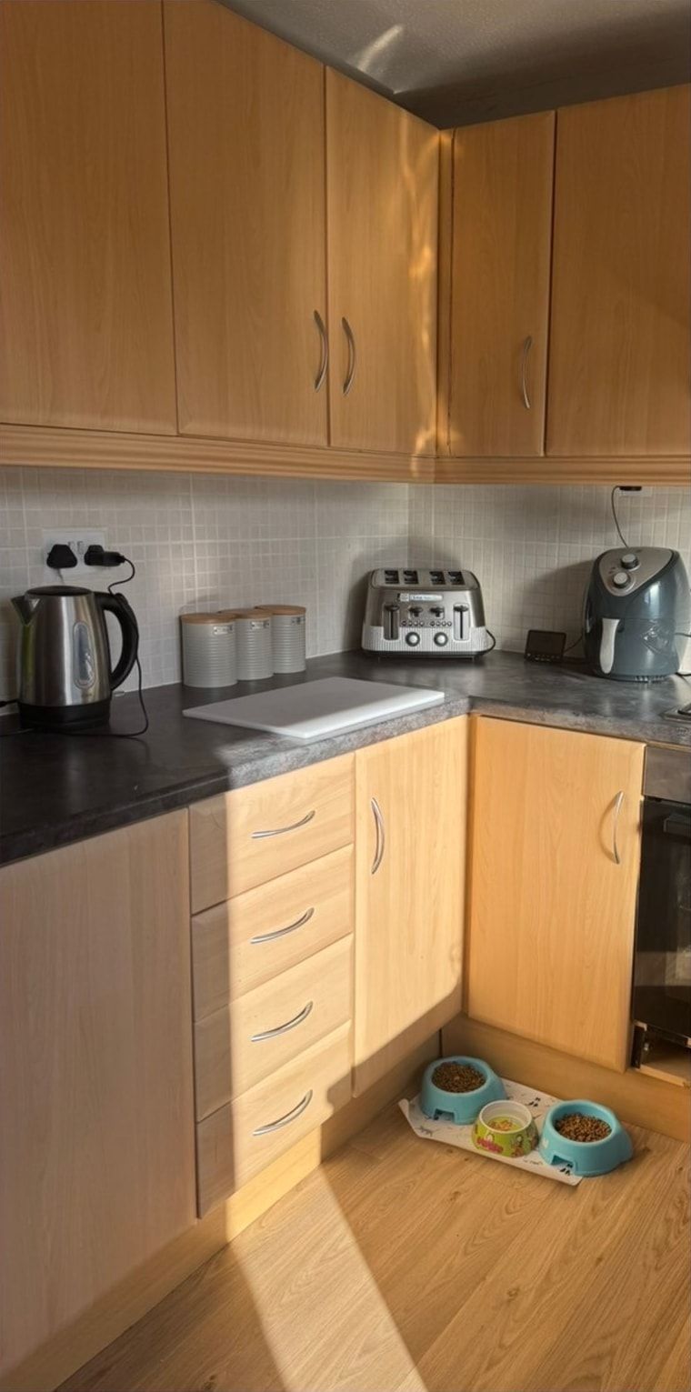 After cleaning: kitchen with wooden cabinets and floor