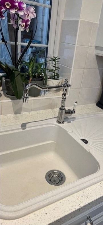 After cleaning: cream kitchen sink and tap