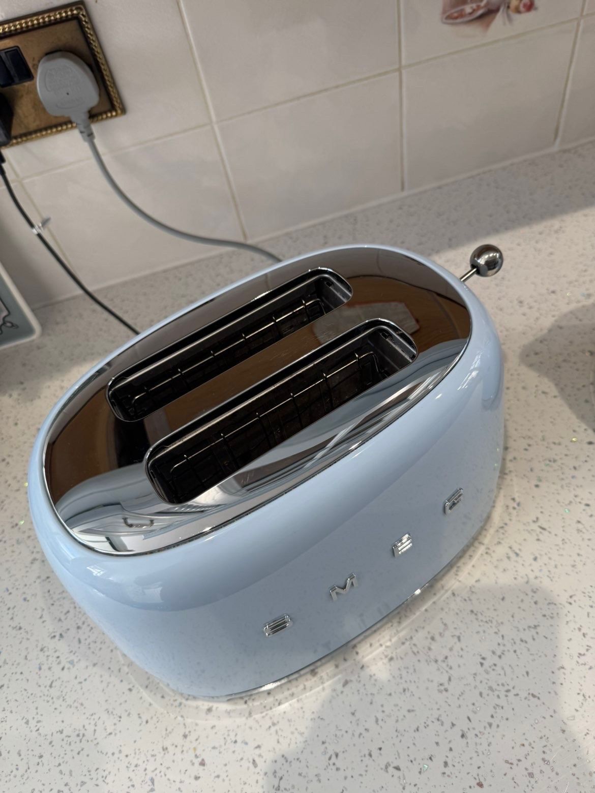 Pastel blue Smeg toaster with gleaming chrome top
